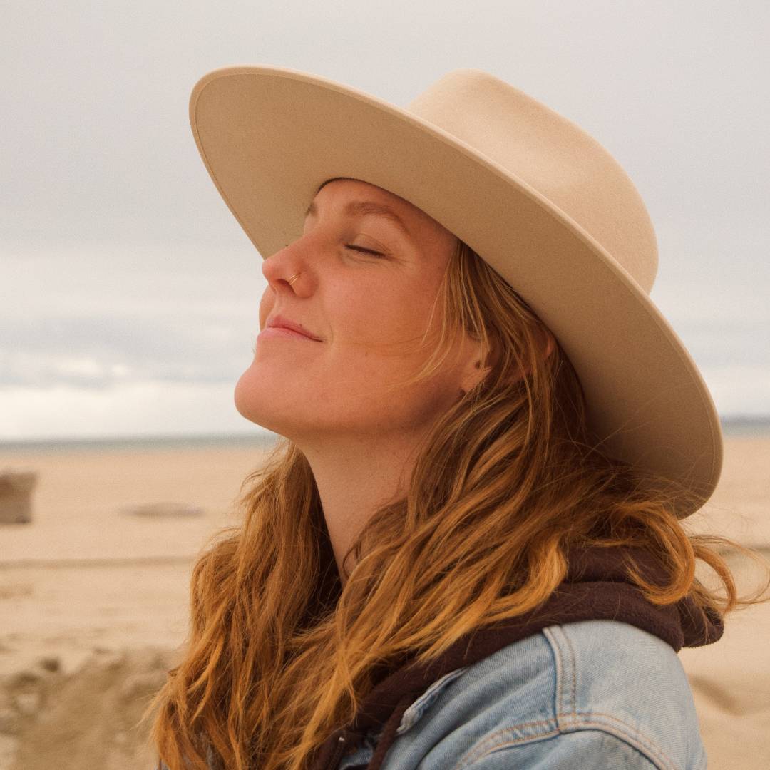 Girl with long hair wearing a wide brim hat