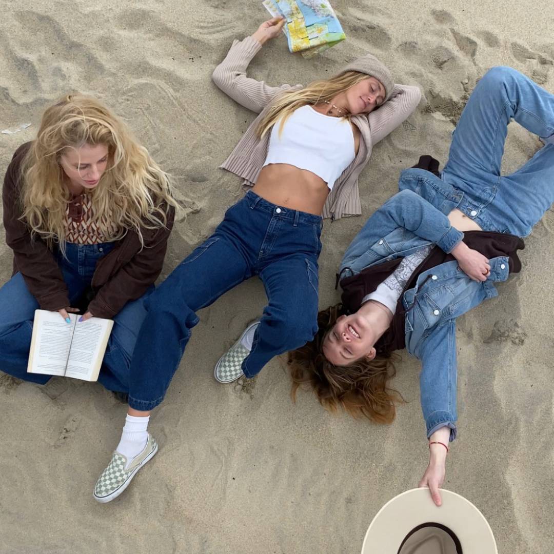 Three girls laying on the beach